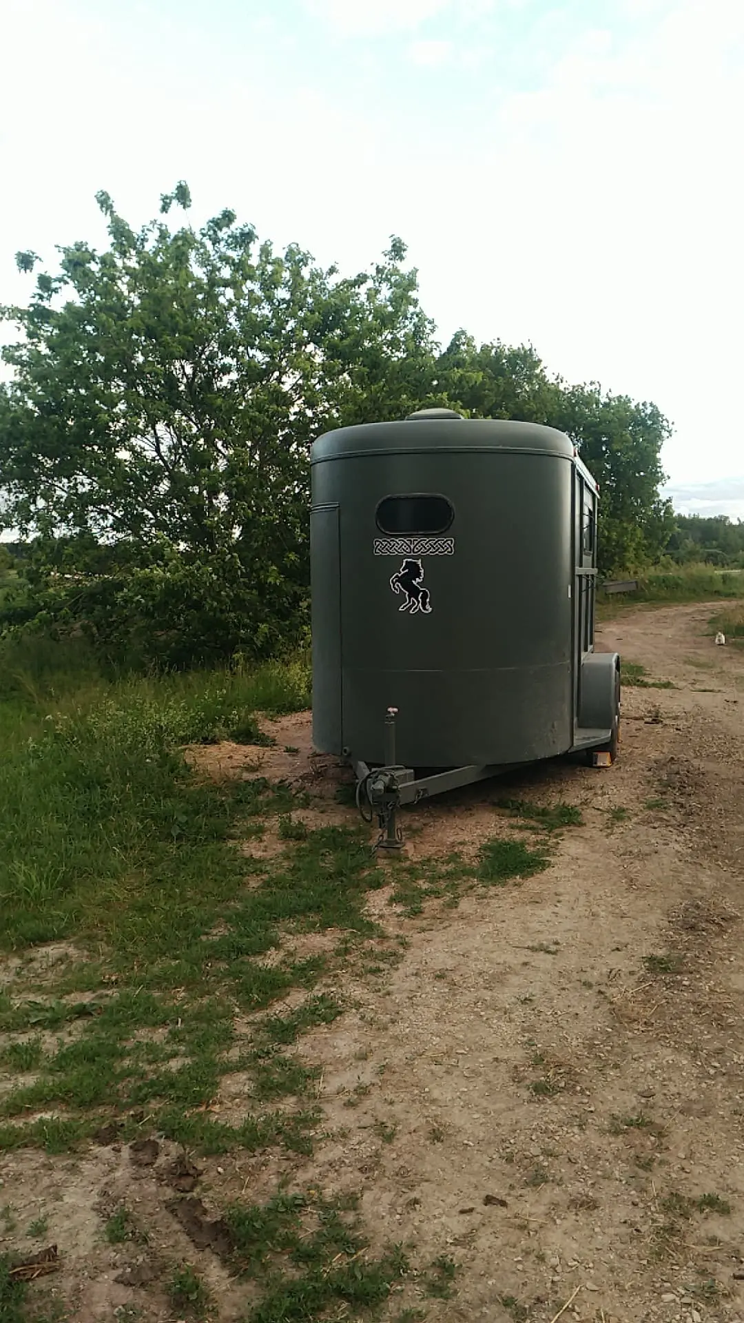 Green horse trailer with Albannach Acres logo on it
